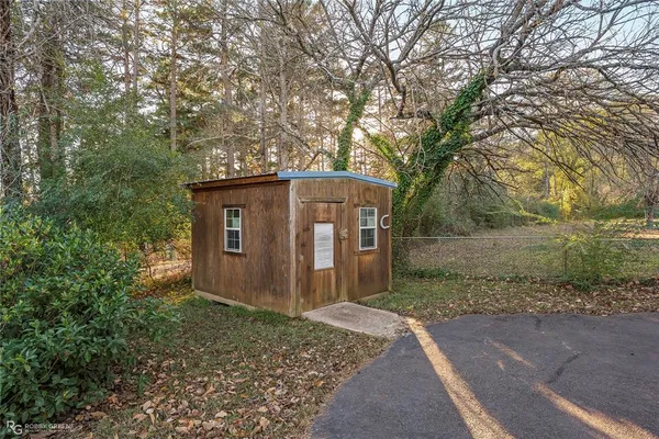 a view of a barn in the middle of a yard