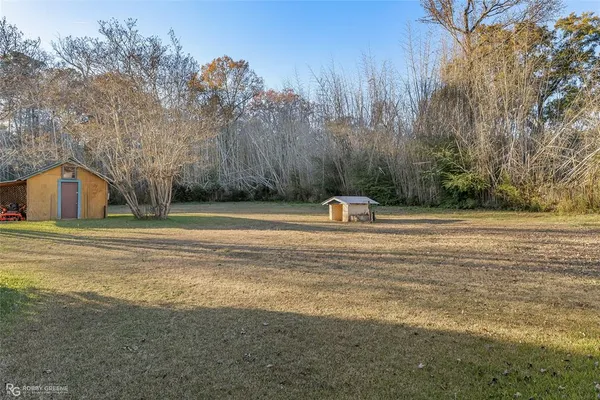 a view of a house with a yard and trees
