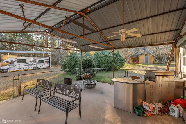 a view of a chairs and table in wooden roof deck