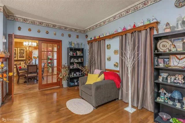 a living room with furniture a bookshelf and a window