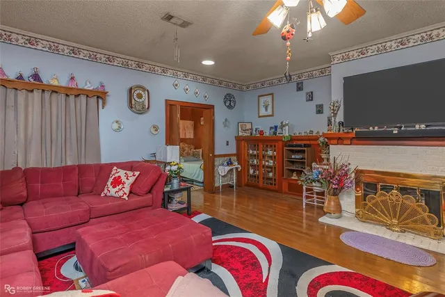 a living room with furniture kitchen view and a flat screen tv