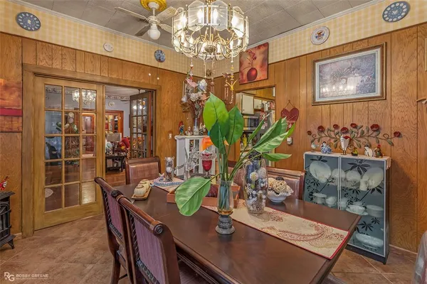 a view of a dining room with furniture and chandelier