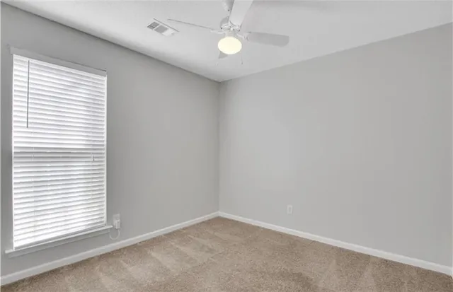 a view of a room with a sink and a mirror