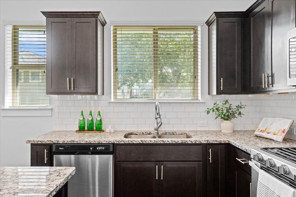 1765 Rowdy Loop, Unit 47 Leander, TX 78641 - Photo 20 of 40 Gleaming granite countertops pair beautifully with dark shaker cabinetry in this updated workspace.