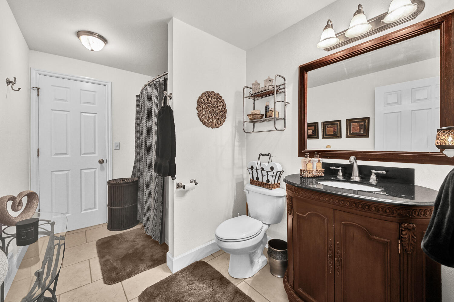 14840 Laurel Road La Pine, OR 97739 - Photo 22 of 32 a bathroom with a toilet sink a mirror a vanity and shower