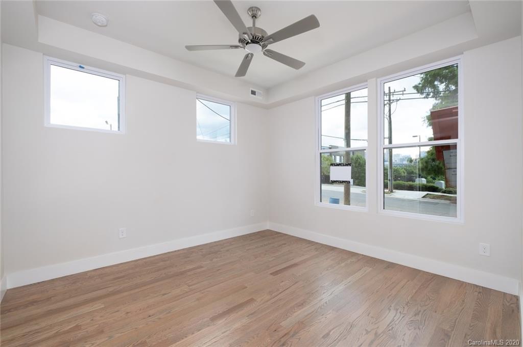 2531 Irwin Stream Road, Unit 20 Charlotte, NC 28208 - Photo 3 of 18 a view of an empty room with wooden floor and a window