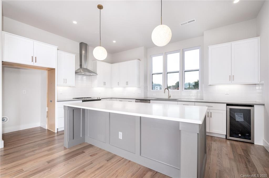 2531 Irwin Stream Road, Unit 20 Charlotte, NC 28208 - Photo 7 of 18 a kitchen with stainless steel appliances granite countertop a sink a stove a refrigerator and a wooden floor