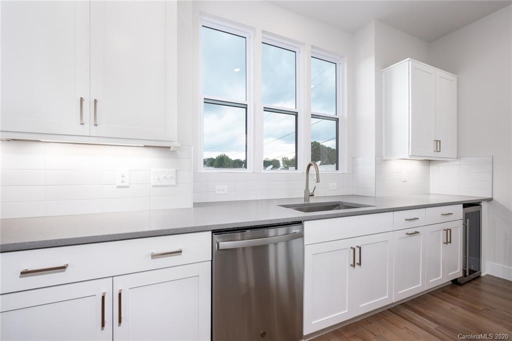 2531 Irwin Stream Road, Unit 20 Charlotte, NC 28208 - Photo 8 of 18 a kitchen with stainless steel appliances white cabinets and a window