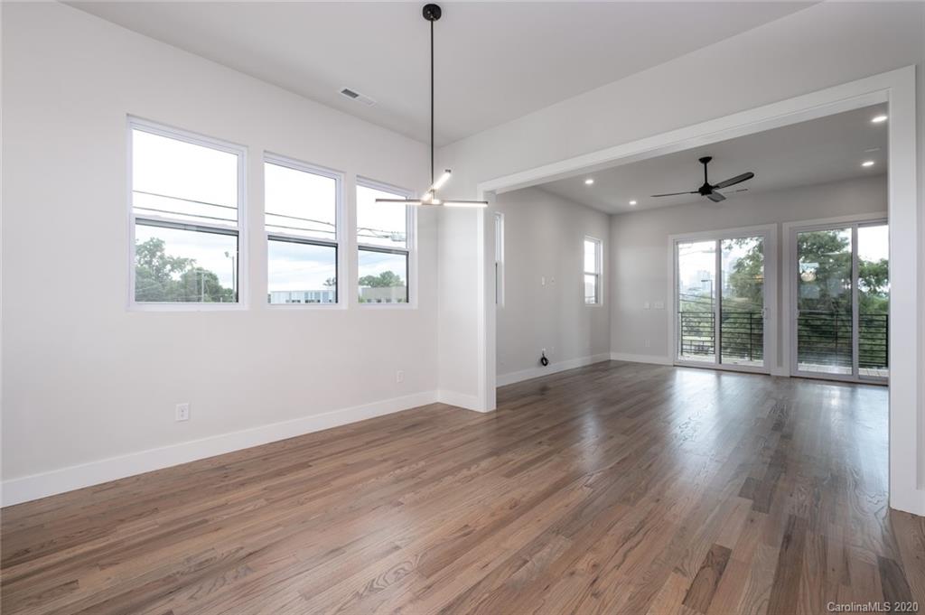2531 Irwin Stream Road, Unit 20 Charlotte, NC 28208 - Photo 9 of 18 a view of an empty room with wooden floor and a window