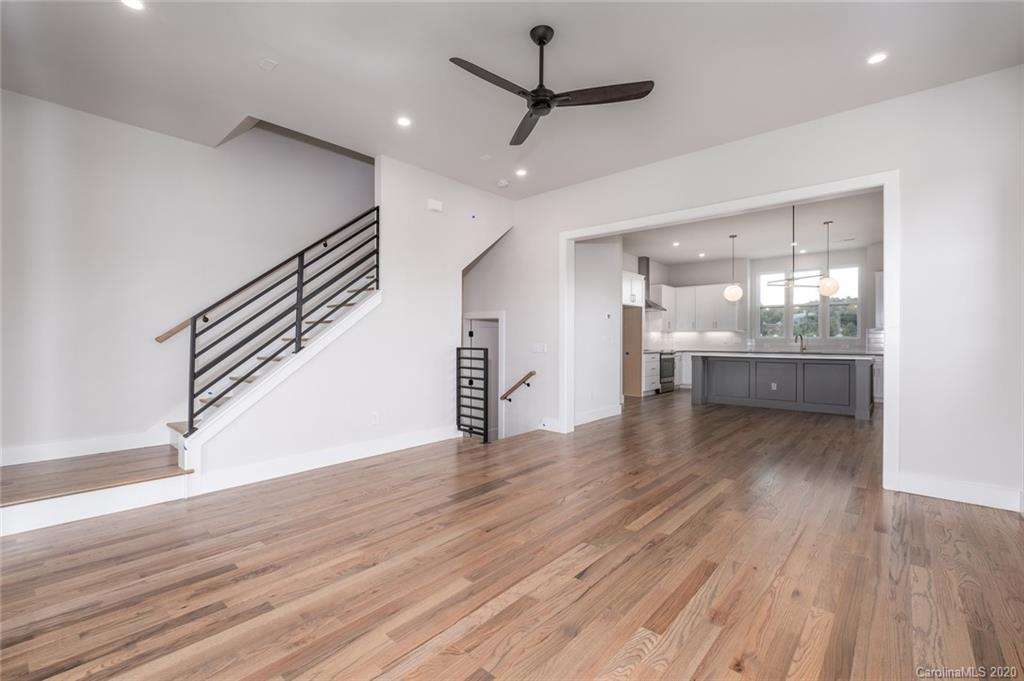 2531 Irwin Stream Road, Unit 20 Charlotte, NC 28208 - Photo 10 of 18 a view of a room with wooden floor a ceiling fan and windows
