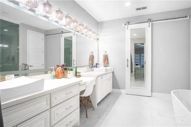 a spacious bathroom with a double vanity sink mirror and double