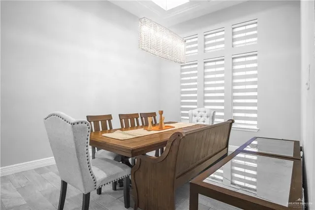 a view of a dining room with furniture and a window