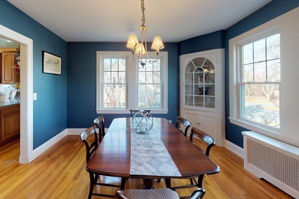 1 Mitchell Road Marblehead, MA 01945 - Photo 10 of 22 a dining room with wooden floor a chandelier a wooden table and chairs