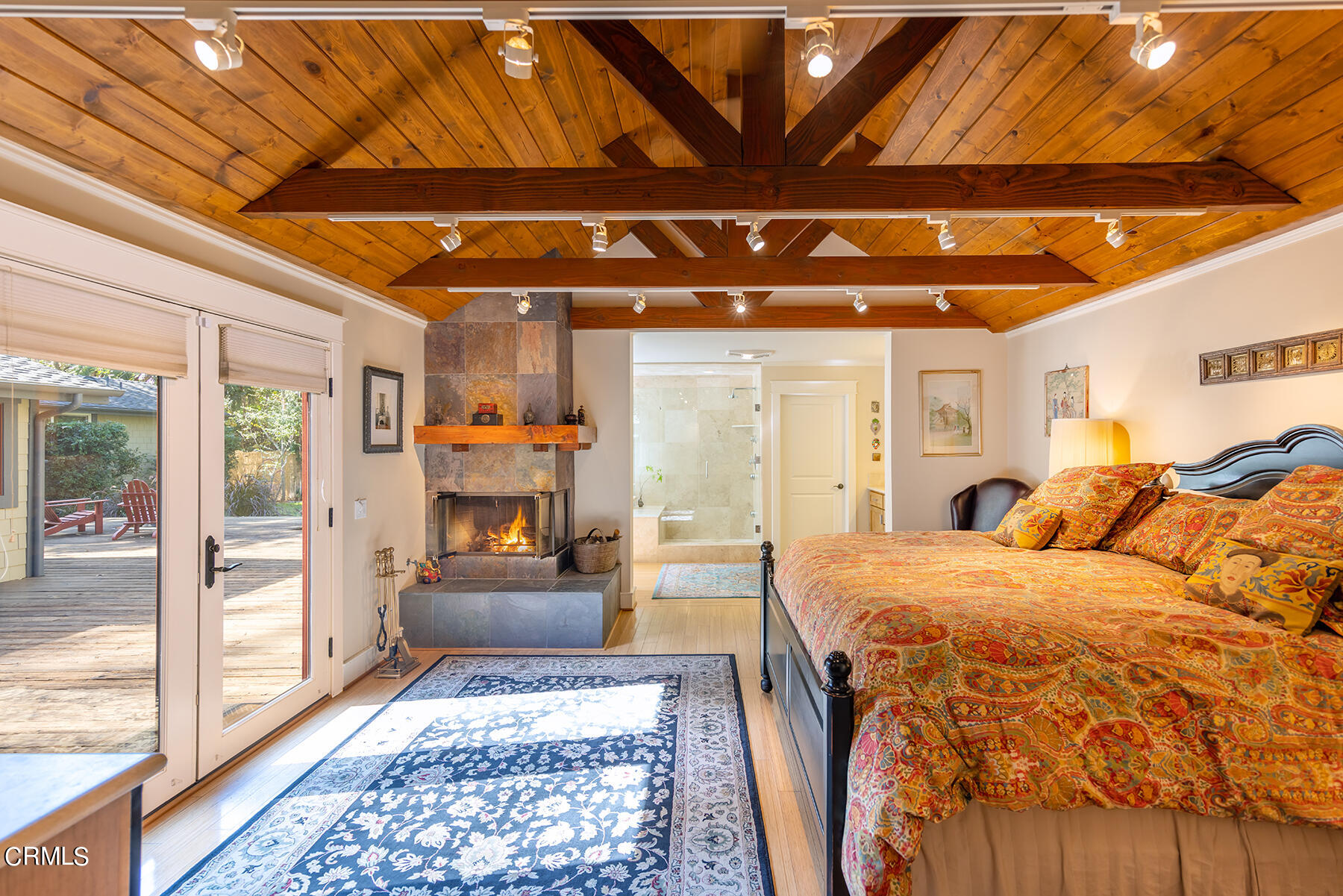487 Gridley Road Ojai, CA 93023 - Photo 13 of 22 a bedroom with a bed and wooden floor