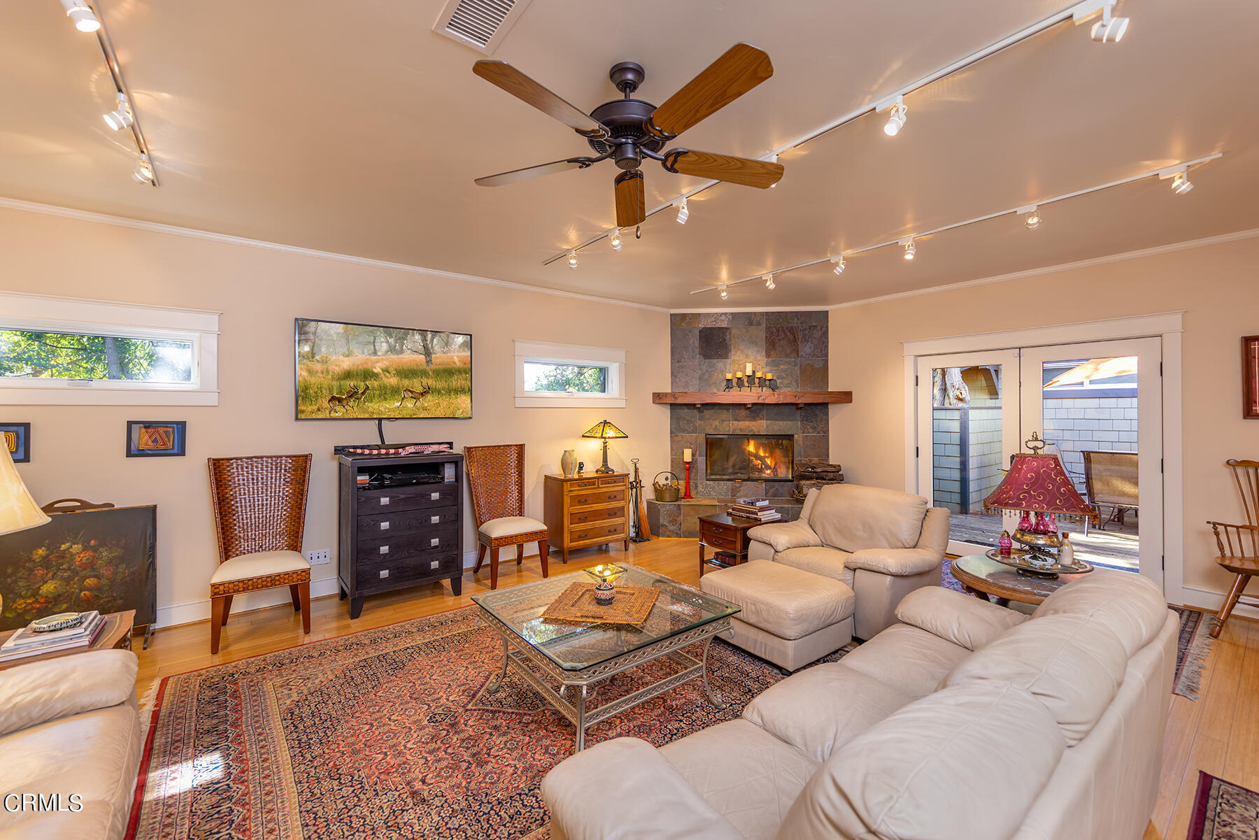 487 Gridley Road Ojai, CA 93023 - Photo 9 of 22 a living room with furniture flat screen tv and a fireplace