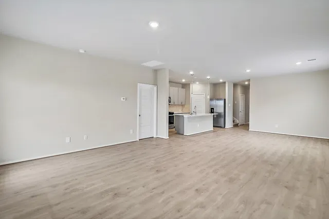 a view of kitchen with refrigerator and window