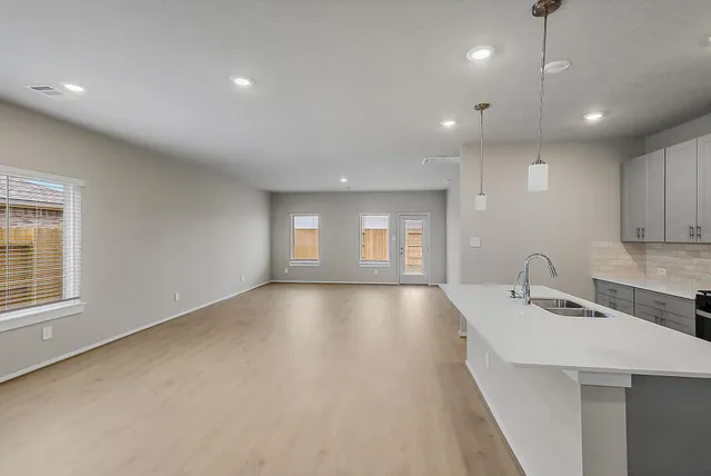 a view of a kitchen with a sink and dishwasher next to a window