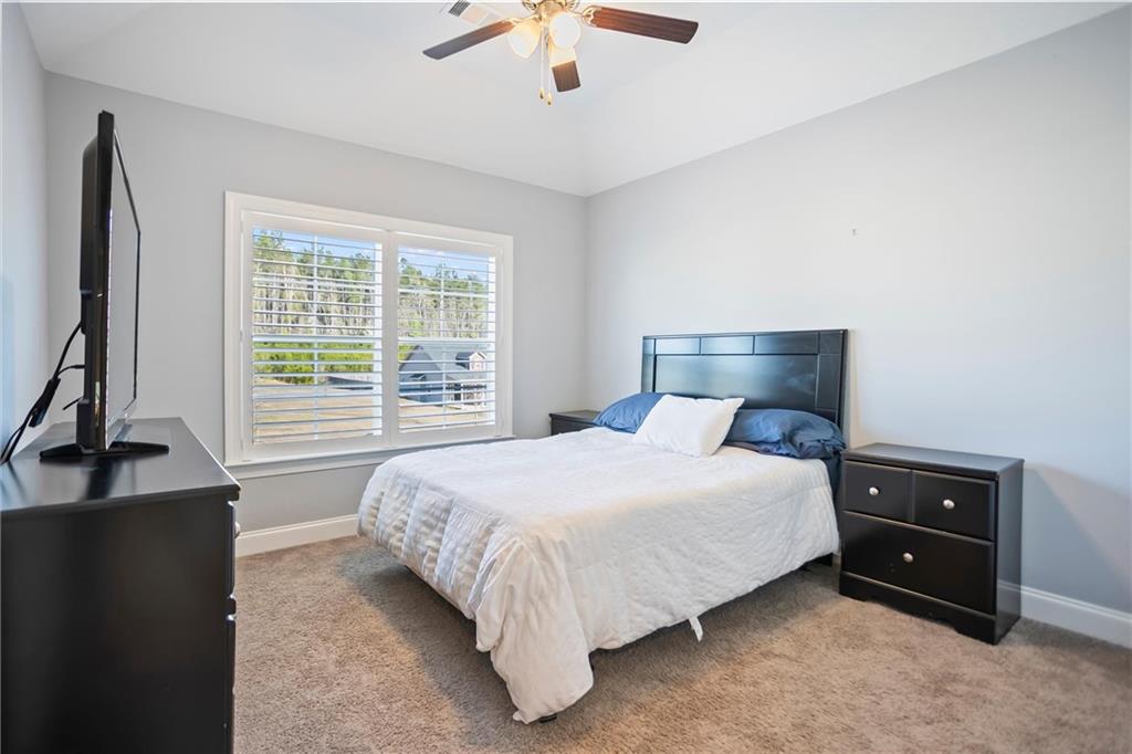 767 Fordham Road Grovetown, GA 30813 - Photo 13 of 32 a bedroom with a bed and a chandelier