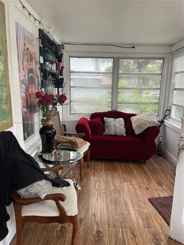 a living room with furniture and a large window
