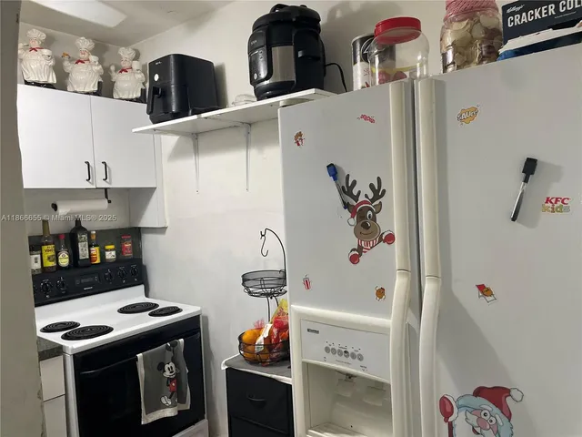 a kitchen with stainless steel appliances and white cabinets