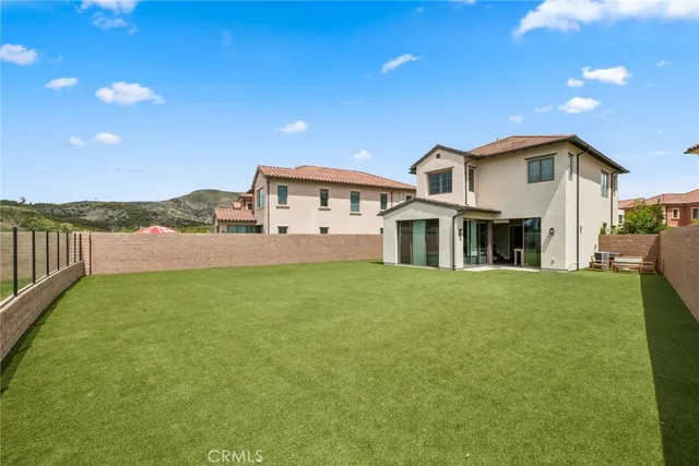 a view of an house with backyard and porch