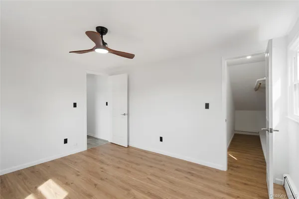 a view of a room with wooden floor