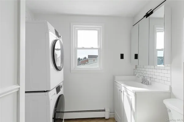 a bathroom with a sink a toilet and a mirror