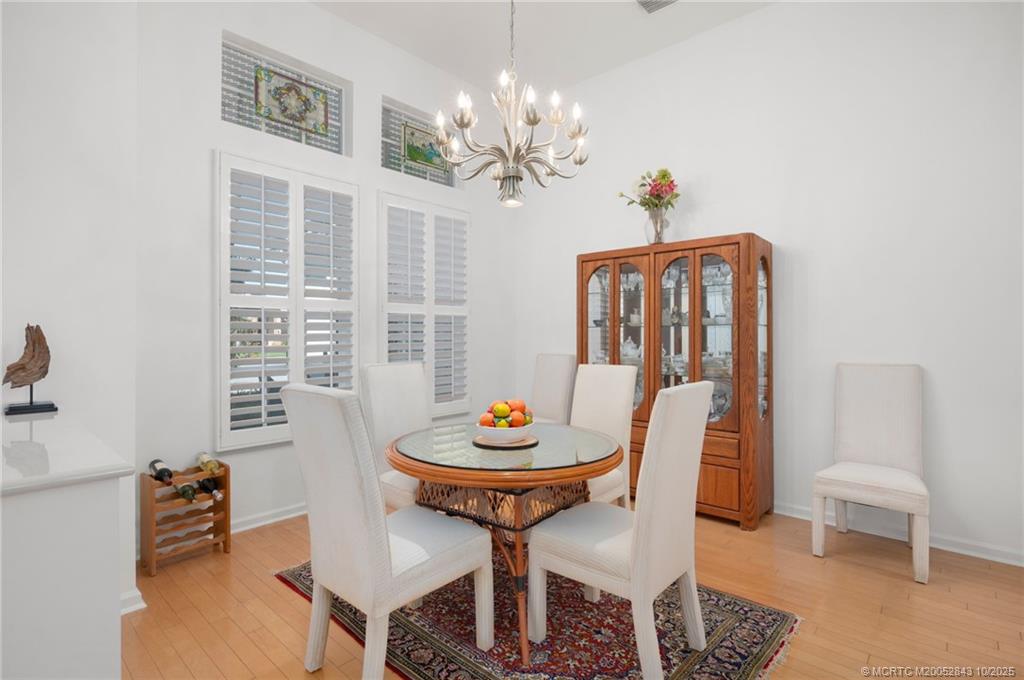 2227 Southeast Stonehaven Road Port St. Lucie, FL 34952 - Photo 14 of 35 a view of a dining room with furniture and a chandelier
