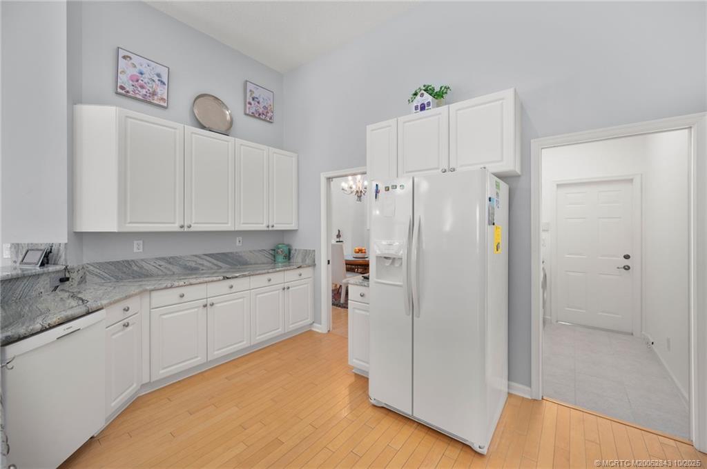 2227 Southeast Stonehaven Road Port St. Lucie, FL 34952 - Photo 19 of 35 a kitchen with a refrigerator and a sink
