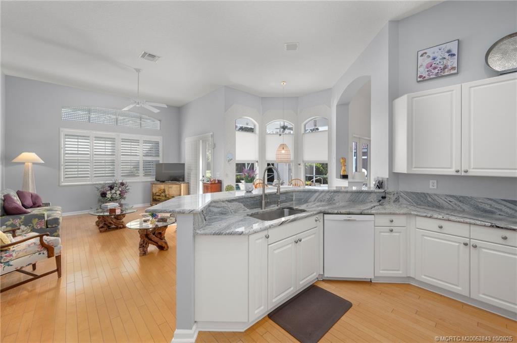 2227 Southeast Stonehaven Road Port St. Lucie, FL 34952 - Photo 21 of 35 a kitchen with a sink stove and cabinets