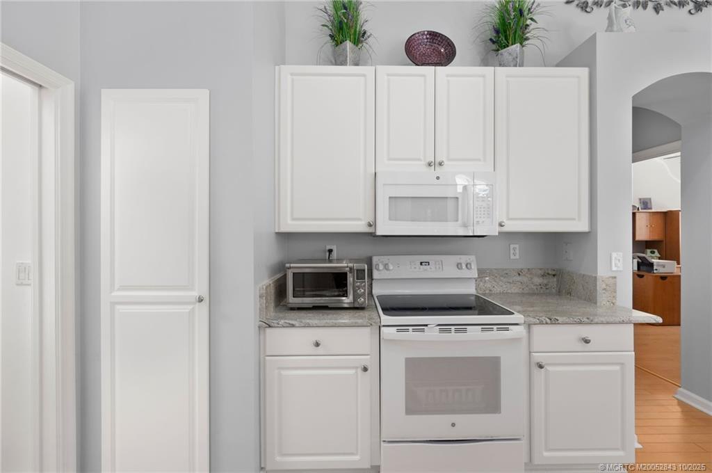 2227 Southeast Stonehaven Road Port St. Lucie, FL 34952 - Photo 23 of 35 a kitchen with white cabinets and sink