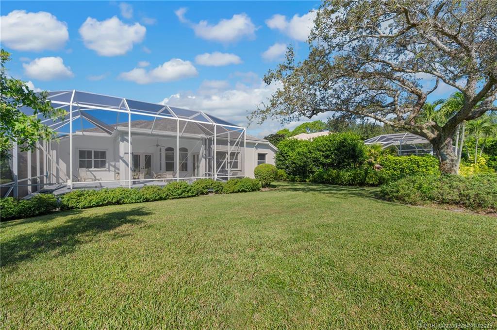 2227 Southeast Stonehaven Road Port St. Lucie, FL 34952 - Photo 31 of 35 a view of a house with a big yard and large trees
