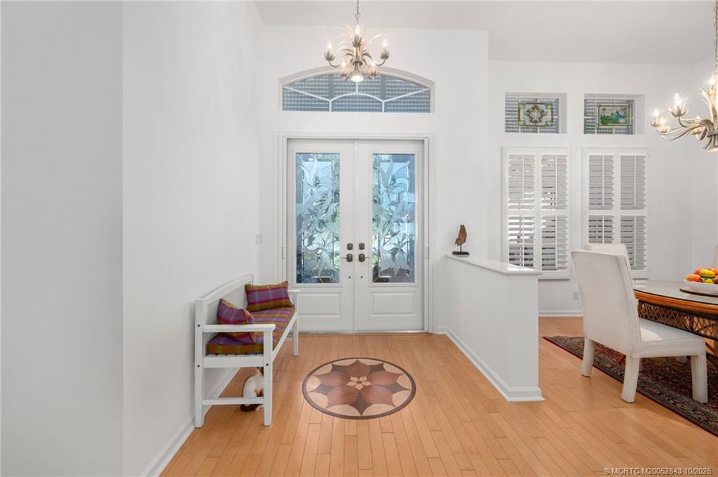 2227 Southeast Stonehaven Road Port St. Lucie, FL 34952 - Photo 4 of 35 a living room with furniture a window and a chandelier