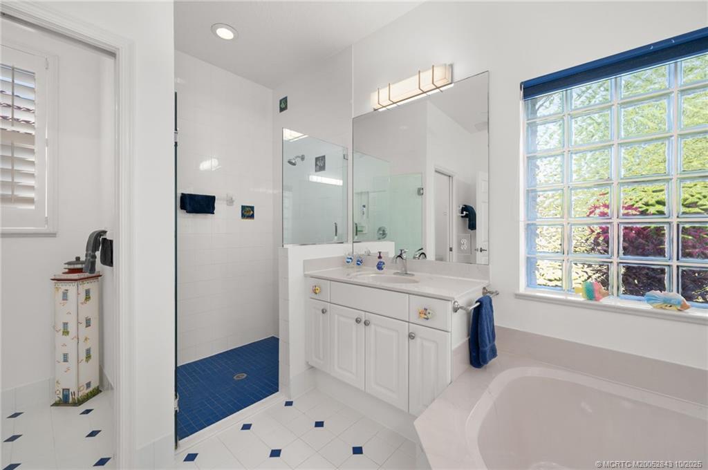 2227 Southeast Stonehaven Road Port St. Lucie, FL 34952 - Photo 9 of 35 a bathroom with a tub sink and a mirror