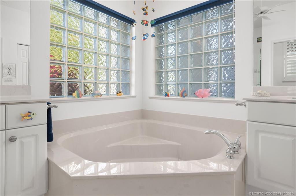 2227 Southeast Stonehaven Road Port St. Lucie, FL 34952 - Photo 10 of 35 a bath tub sitting next to a window
