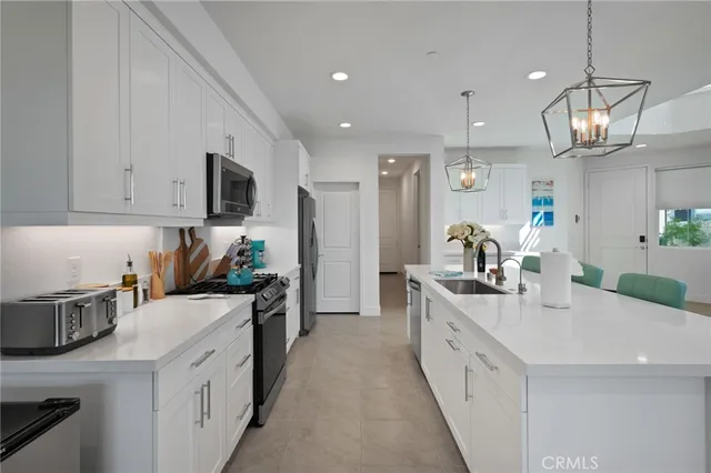 a kitchen with a sink stove and microwave