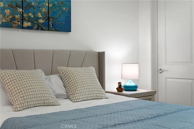 a bedroom with bed and night stand