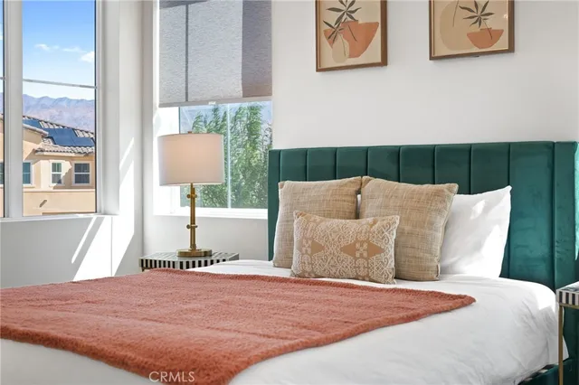 a living room with patio furniture and a floor to ceiling window