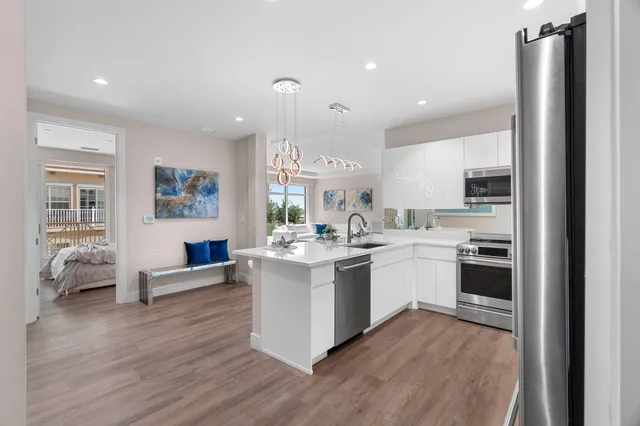 a kitchen with a sink stainless steel appliances and cabinets