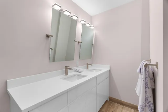 a bathroom with a sink a shower and a mirror