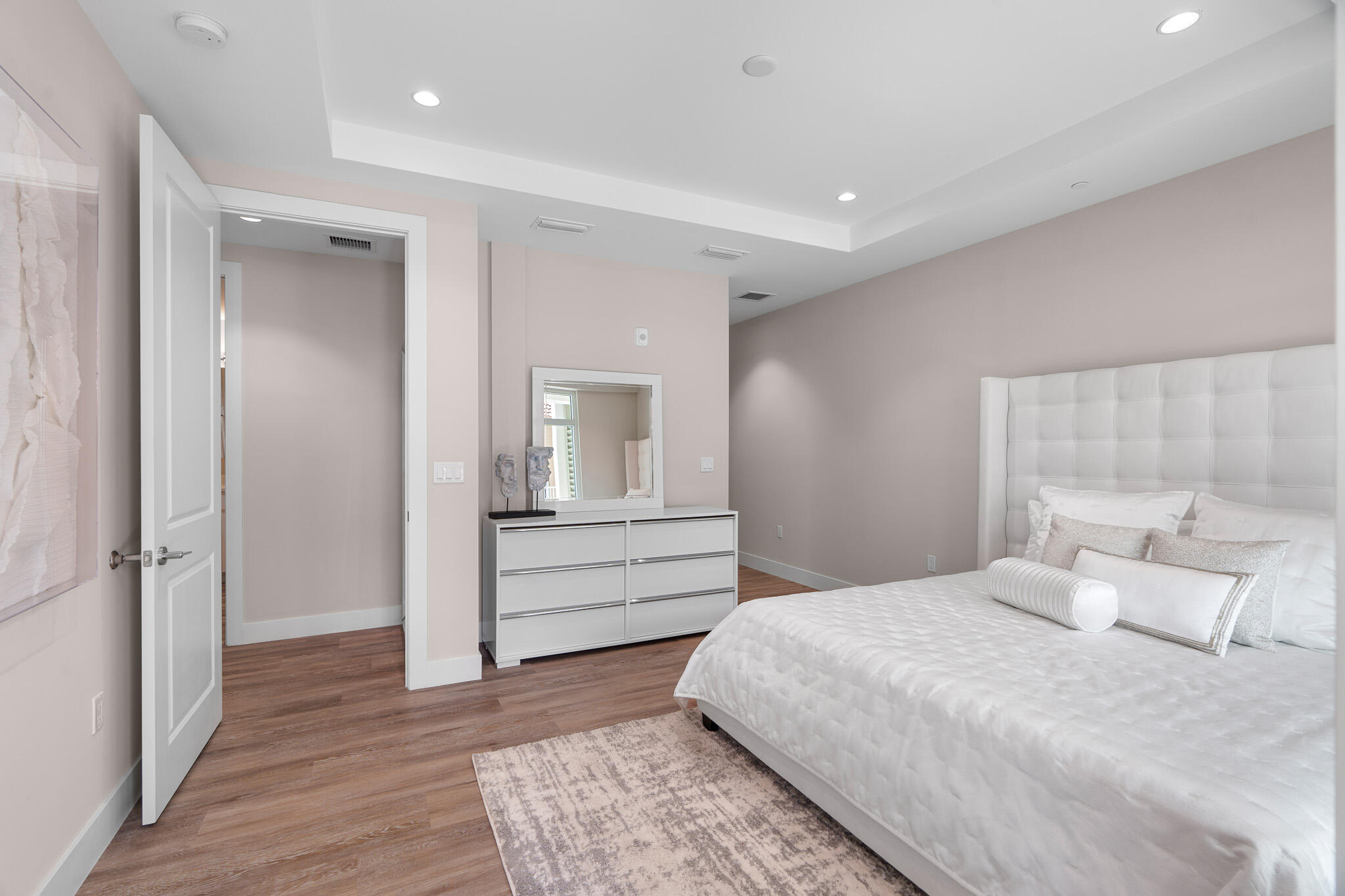 41 Southwest Seminole Street, Unit 310 Stuart, FL 34994 - Photo 36 of 55 a room with a bed and a mirror