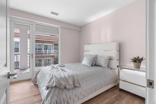 a bedroom with a bed and a large window