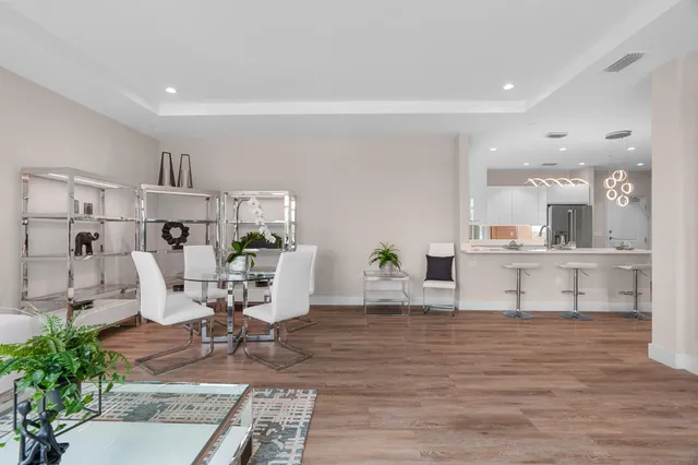 a living room with furniture and view of kitchen