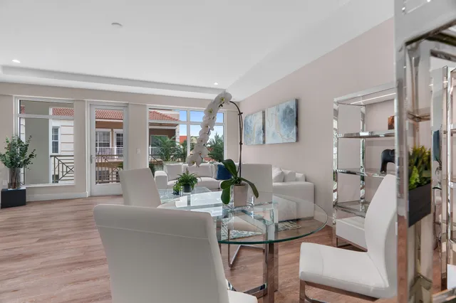 a living room with furniture and potted plants