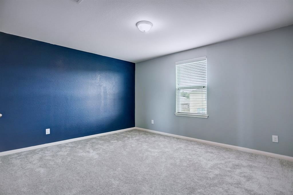1303 Emerald Stone Drive Rosharon, TX 77583 - Photo 19 of 25 Generously sized upstairs bedroom with versatile space ideal for family, guests, or a home office.