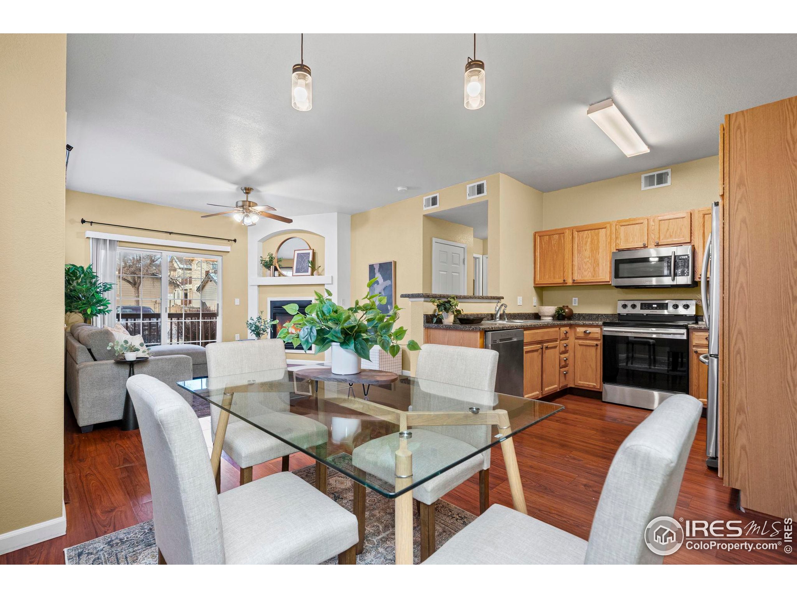 3002 West Elizabeth Street, Unit D Fort Collins, CO 80521 - Photo 10 of 23 a living room with stainless steel appliances kitchen island granite countertop furniture and a view of kitchen