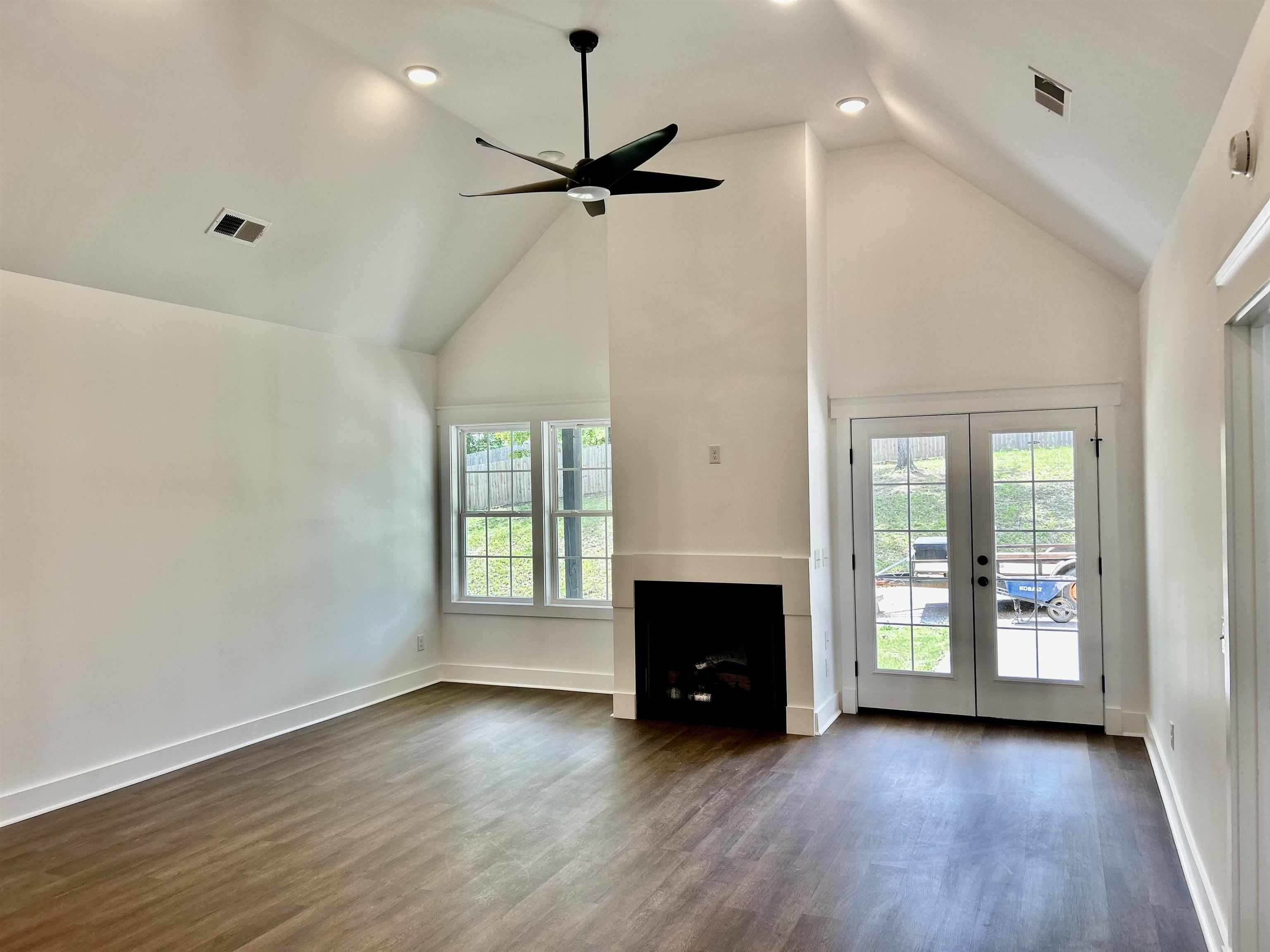 35 Grapevine Cove Counce, TN 38326 - Photo 4 of 25 an empty room with wooden floor fireplace and windows
