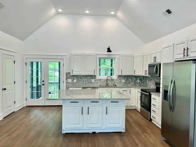 a kitchen with stainless steel appliances granite countertop a stove and a refrigerator