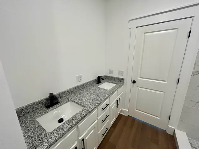 a bathroom with a granite countertop sink and vanity