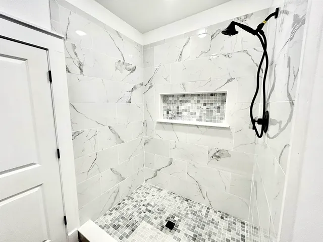 a bathroom with a shower and a shower
